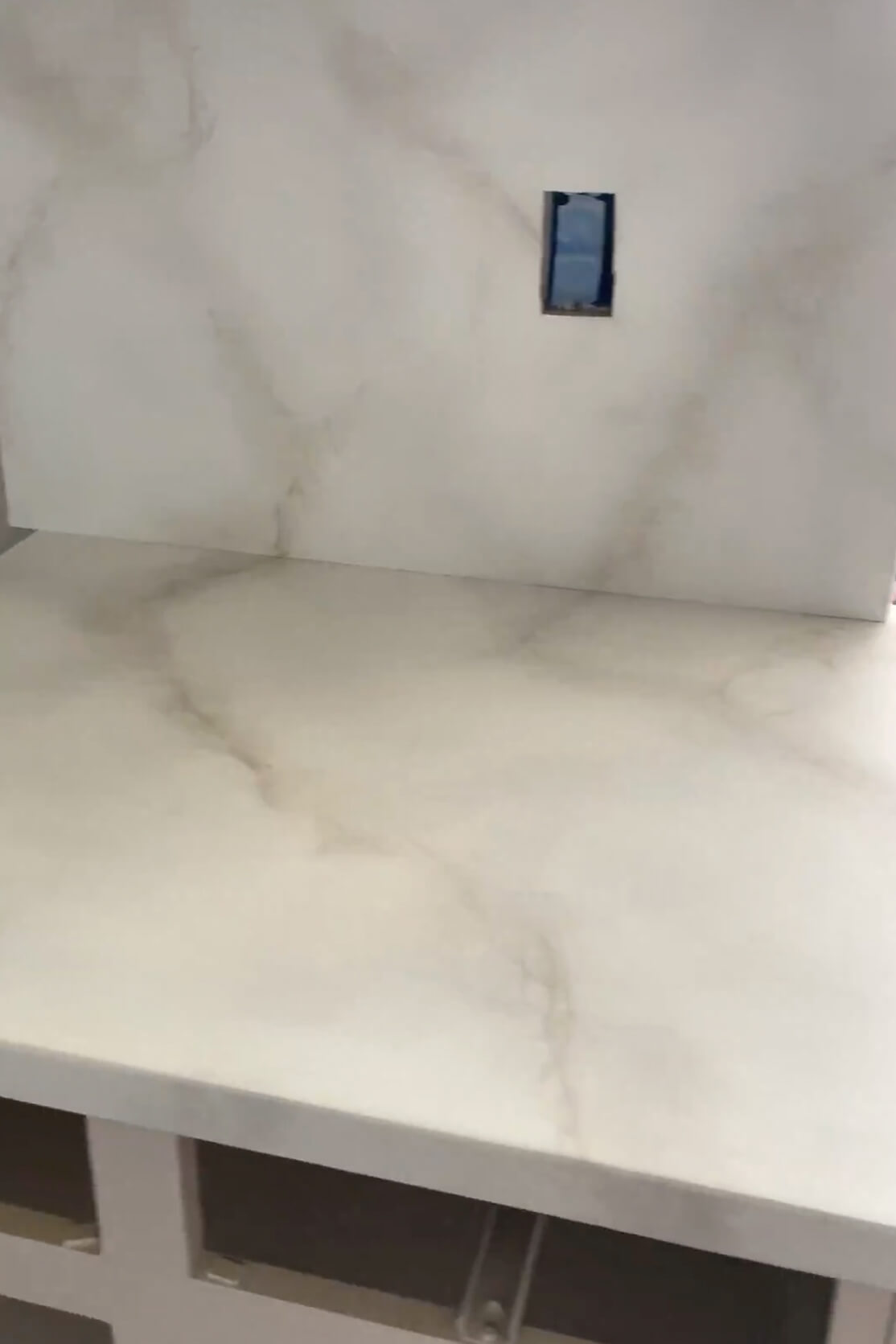 Painting a countertop for a faux marble finish. 